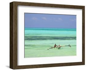 Tanzania, Zanzibar, Unguja, Jambiani, a Man Sits on His Boat Near the Shore-Nick Ledger-Framed Photographic Print