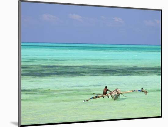 Tanzania, Zanzibar, Unguja, Jambiani, a Man Sits on His Boat Near the Shore-Nick Ledger-Mounted Photographic Print