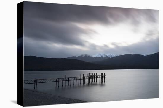 Te Anau jetty with lake and mountain in background, Southland, South Island, New Zealand-Ed Rhodes-Stretched Canvas