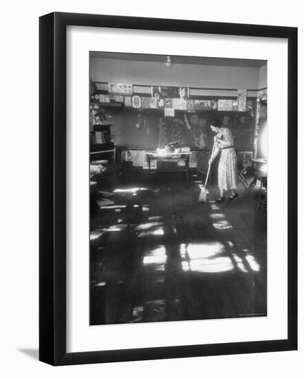 Teacher stays behind to give school final sweeping on the last day after everyone has gone home-Thomas D^ Mcavoy-Framed Photographic Print