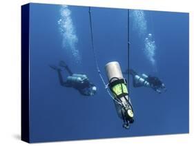 Technical Divers Ascend Near a Nitrox Stage Bottl-null-Stretched Canvas