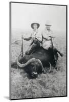 Teddy Roosevelt Sitting on Dead Water Buffalo with Rifle-null-Mounted Photographic Print