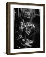 Teenage Boy Peering Into Window of Ticket Booth at a Movie Theater-Yale Joel-Framed Photographic Print