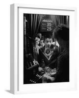 Teenage Boy Peering Into Window of Ticket Booth at a Movie Theater-Yale Joel-Framed Photographic Print