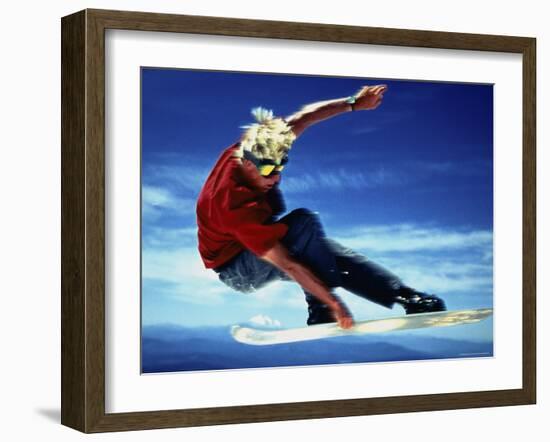 Teenage Boy Snowboarding in Mid-Air-null-Framed Photographic Print