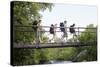 Teenage Boys and Girls with Backpacks Walking on Bridge in Forest-Nosnibor137-Stretched Canvas