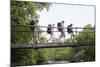 Teenage Boys and Girls with Backpacks Walking on Bridge in Forest-Nosnibor137-Mounted Photographic Print