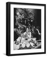 Teenage Girl Hugging Stuffed Animals under Christmas Tree-null-Framed Photo