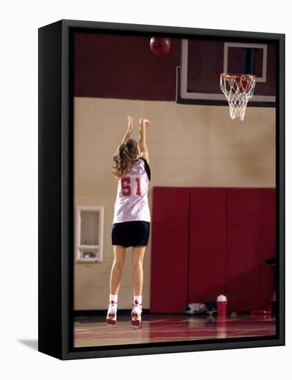 Teenage Girl Practicing Basketball Indoors-null-Framed Stretched Canvas
