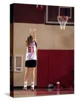 Teenage Girl Practicing Basketball Indoors-null-Stretched Canvas