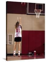 Teenage Girl Practicing Basketball Indoors-null-Stretched Canvas