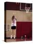 Teenage Girl Practicing Basketball Indoors-null-Stretched Canvas