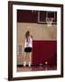 Teenage Girl Practicing Basketball Indoors-null-Framed Photographic Print