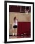 Teenage Girl Practicing Basketball Indoors-null-Framed Photographic Print