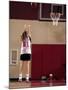 Teenage Girl Practicing Basketball Indoors-null-Mounted Photographic Print