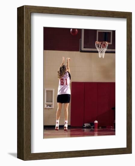 Teenage Girl Practicing Basketball Indoors-null-Framed Photographic Print