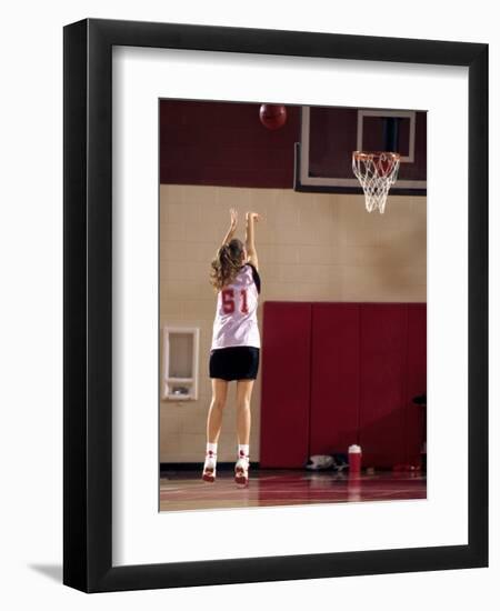 Teenage Girl Practicing Basketball Indoors-null-Framed Photographic Print