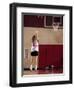 Teenage Girl Practicing Basketball Indoors-null-Framed Photographic Print