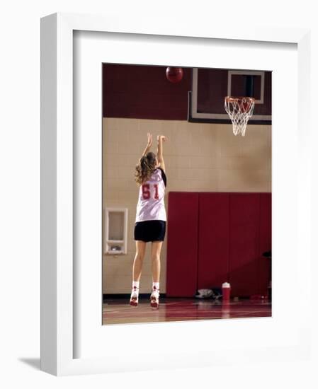 Teenage Girl Practicing Basketball Indoors-null-Framed Photographic Print