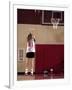 Teenage Girl Practicing Basketball Indoors-null-Framed Photographic Print