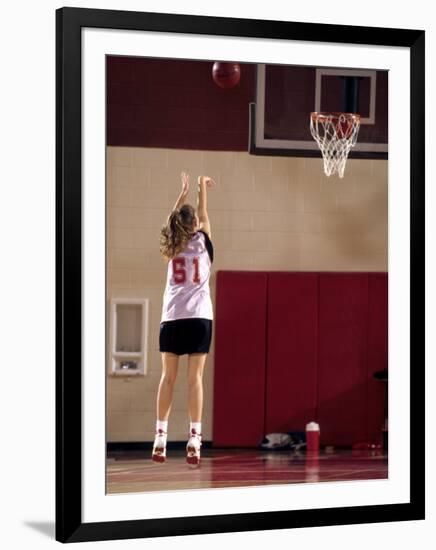 Teenage Girl Practicing Basketball Indoors-null-Framed Photographic Print