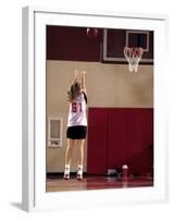 Teenage Girl Practicing Basketball Indoors-null-Framed Photographic Print
