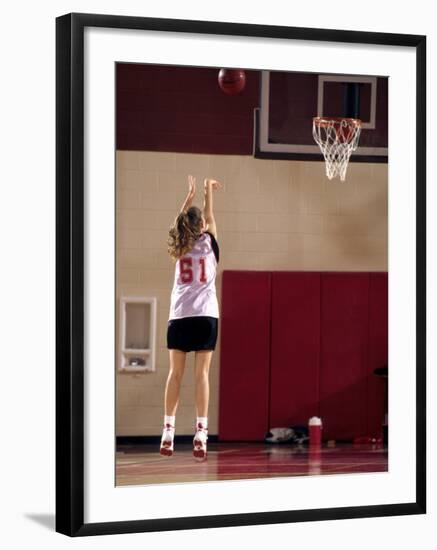 Teenage Girl Practicing Basketball Indoors-null-Framed Photographic Print