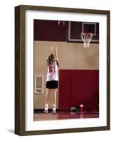 Teenage Girl Practicing Basketball Indoors-null-Framed Photographic Print