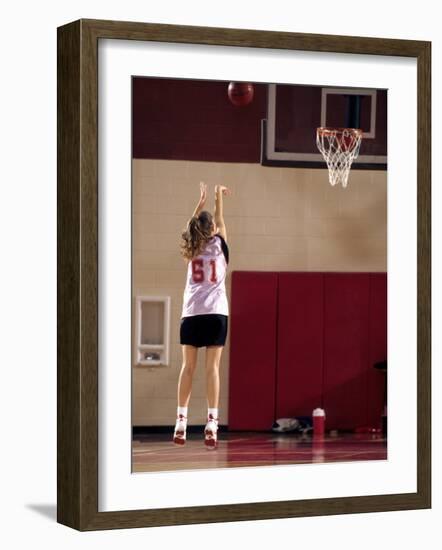 Teenage Girl Practicing Basketball Indoors-null-Framed Photographic Print