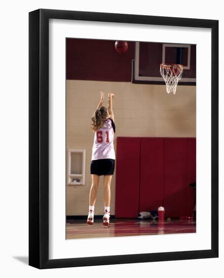 Teenage Girl Practicing Basketball Indoors-null-Framed Photographic Print