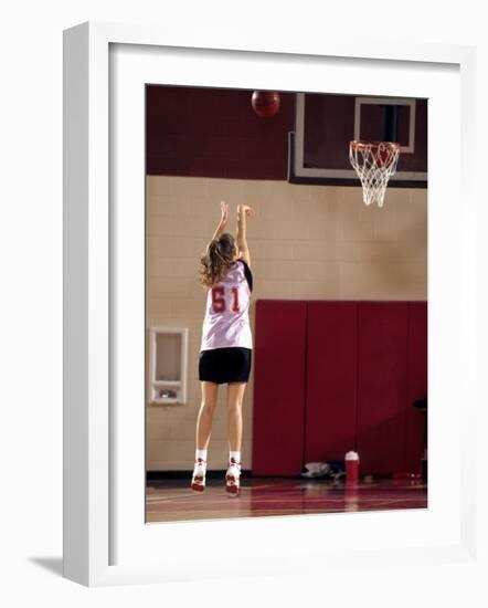 Teenage Girl Practicing Basketball Indoors-null-Framed Photographic Print