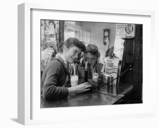 Teenage Girls Drinking Milkshakes at a Local Restaurant-Francis Miller-Framed Photographic Print