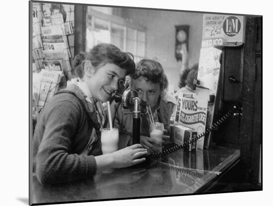 Teenage Girls Drinking Milkshakes at a Local Restaurant-Francis Miller-Mounted Photographic Print