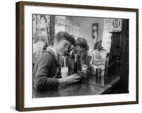 Teenage Girls Drinking Milkshakes at a Local Restaurant-Francis Miller-Framed Photographic Print