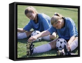 Teenage Girls in Soccer Uniforms Doing Stretching Exercises-null-Framed Stretched Canvas