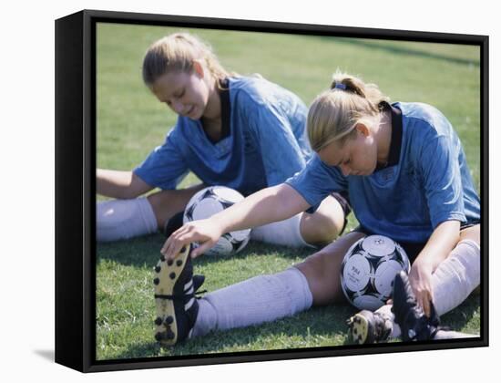 Teenage Girls in Soccer Uniforms Doing Stretching Exercises-null-Framed Stretched Canvas