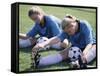 Teenage Girls in Soccer Uniforms Doing Stretching Exercises-null-Framed Stretched Canvas