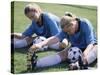 Teenage Girls in Soccer Uniforms Doing Stretching Exercises-null-Stretched Canvas