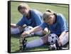 Teenage Girls in Soccer Uniforms Doing Stretching Exercises-null-Framed Stretched Canvas