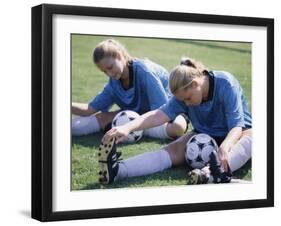 Teenage Girls in Soccer Uniforms Doing Stretching Exercises-null-Framed Premium Photographic Print