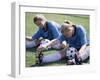 Teenage Girls in Soccer Uniforms Doing Stretching Exercises-null-Framed Premium Photographic Print