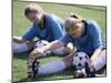 Teenage Girls in Soccer Uniforms Doing Stretching Exercises-null-Mounted Premium Photographic Print