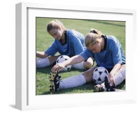 Teenage Girls in Soccer Uniforms Doing Stretching Exercises-null-Framed Photographic Print