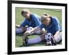 Teenage Girls in Soccer Uniforms Doing Stretching Exercises-null-Framed Photographic Print