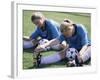 Teenage Girls in Soccer Uniforms Doing Stretching Exercises-null-Framed Photographic Print