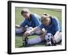 Teenage Girls in Soccer Uniforms Doing Stretching Exercises-null-Framed Photographic Print