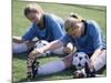 Teenage Girls in Soccer Uniforms Doing Stretching Exercises-null-Mounted Photographic Print