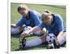 Teenage Girls in Soccer Uniforms Doing Stretching Exercises-null-Framed Photographic Print