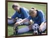 Teenage Girls in Soccer Uniforms Doing Stretching Exercises-null-Framed Photographic Print