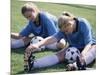 Teenage Girls in Soccer Uniforms Doing Stretching Exercises-null-Mounted Photographic Print